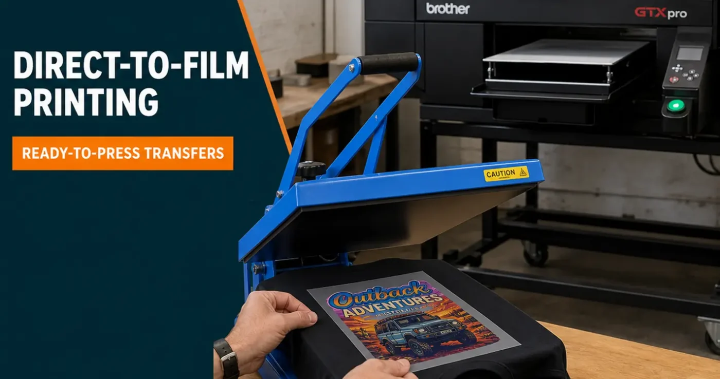 Direct-to-film printing workflow: ready-to-press DTF film on a black t-shirt in a George Knight heat press, Brother GTX Pro Bulk in the background