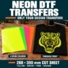 Solid yellow, green, pink and orange neon DTF sheets beside a black T-shirt with a neon yellow tiger print.