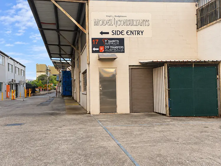 DTF Transfers Australia and T Shirts Australia signage at 17 Castlemaine Street, Coorparoo, pointing towards the shop down the laneway.